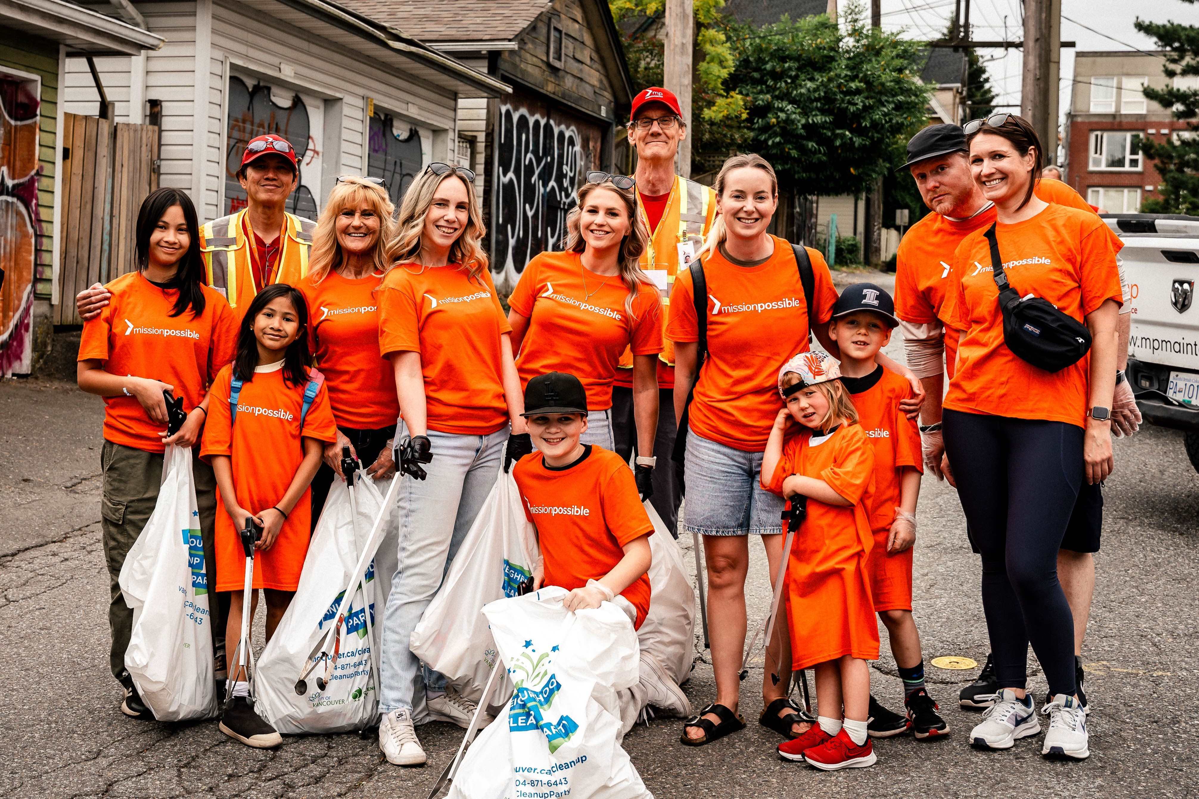 Group of Mission Possible volunteers posing with collected garbage bags after a clean-up activity