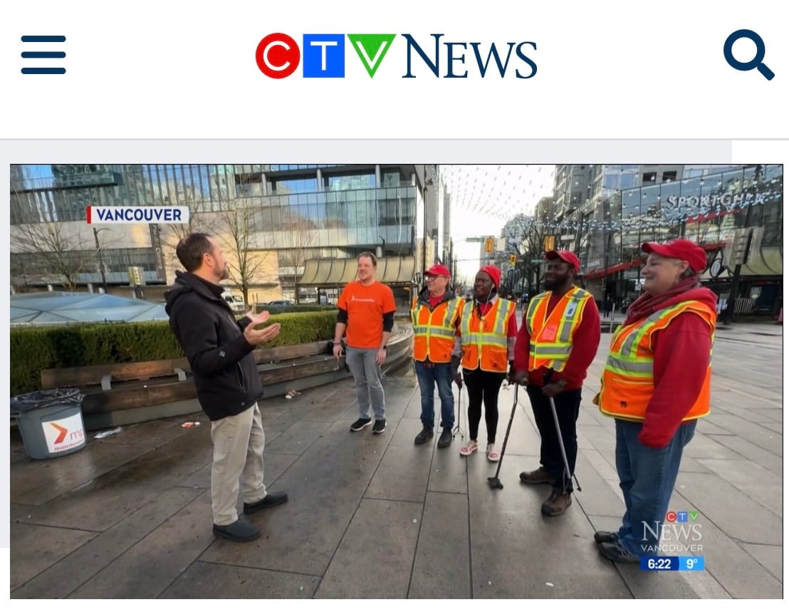 Matthew Smedley and Mission Possible team standing at Robson Square celebrating the one millionth piece of litter picked up by our teams. 